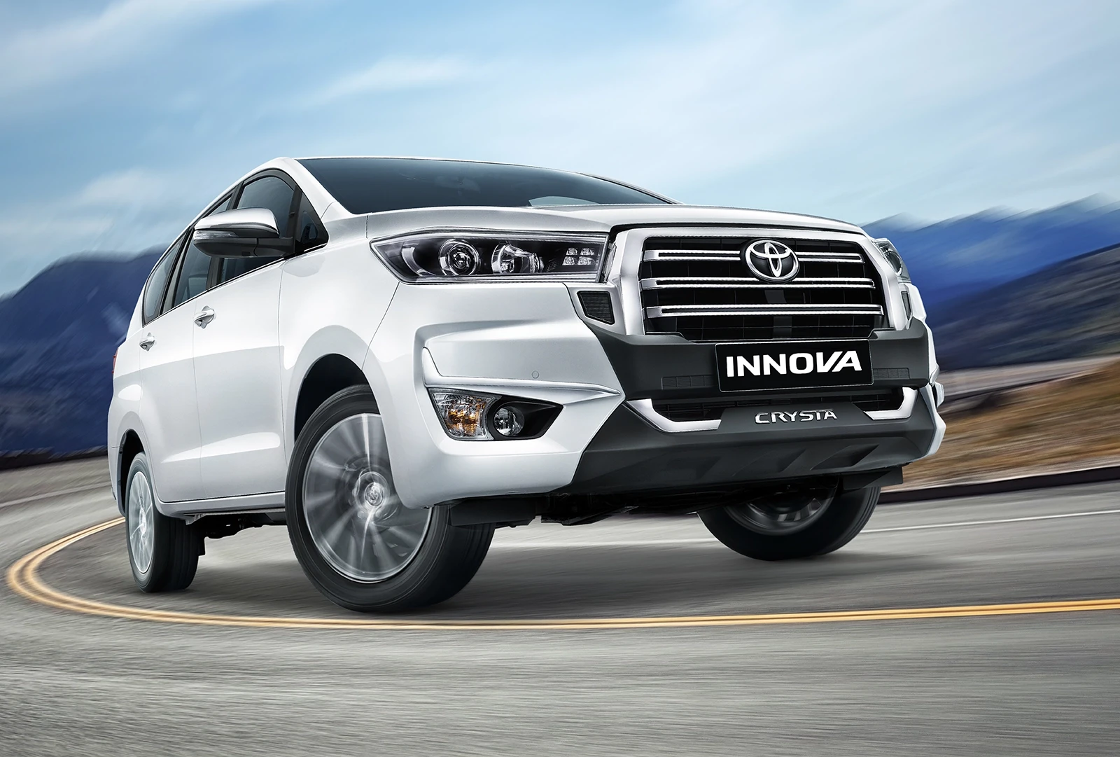 Innova Crysta driving through mountain country