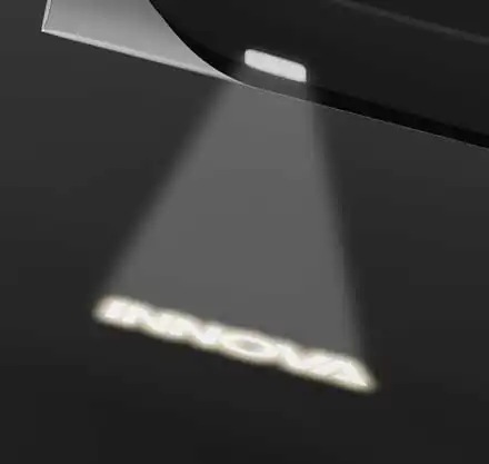 Innova Crysta welcome door lamp projecting the INNOVA logo