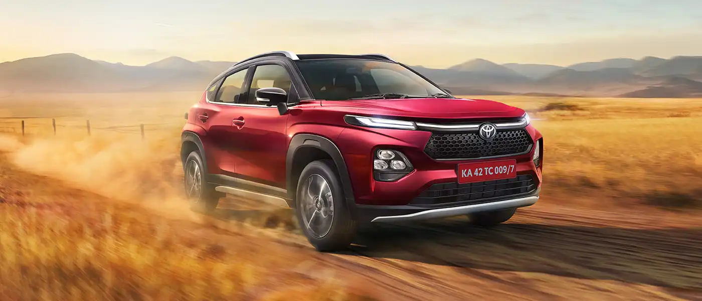 Toyota Urban Cruiser Taisor on a dirt trail through open grassland